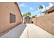Side yard with a shed and concrete path and a block wall at 7214 W Crest Ln, Glendale, AZ 85310