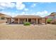 Spacious backyard featuring a covered patio and low-maintenance desert landscaping at 7214 W Crest Ln, Glendale, AZ 85310