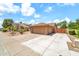Side view of home with a two-car garage and additional parking space at 7214 W Crest Ln, Glendale, AZ 85310