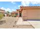 Inviting home exterior with a tile roof, desert landscaping, and a two-car garage at 7214 W Crest Ln, Glendale, AZ 85310