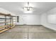 Spacious garage with storage shelves and a door leading to the home's interior at 7214 W Crest Ln, Glendale, AZ 85310