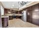Well-equipped kitchen features stainless steel appliances and dark wood cabinetry at 7214 W Crest Ln, Glendale, AZ 85310