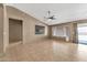 Spacious living room featuring tile floors and a ceiling fan at 7214 W Crest Ln, Glendale, AZ 85310