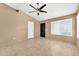 Inviting living room features neutral tones, large windows, and ceiling fan at 7214 W Crest Ln, Glendale, AZ 85310