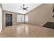 Inviting living room with tile flooring, ceiling fan, and ample natural light at 7214 W Crest Ln, Glendale, AZ 85310