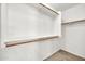 This walk-in closet features built-in wooden rods and shelving for optimal storage and organization at 7214 W Crest Ln, Glendale, AZ 85310