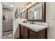 Cozy bathroom features an updated vanity, large mirror and stand up shower at 7777 E Main St # 143, Scottsdale, AZ 85251