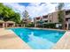 A sparkling community pool with plenty of space for swimming laps with mature trees and landscaping at 7777 E Main St # 143, Scottsdale, AZ 85251