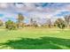 Lush community golf course featuring expansive green space under a bright blue sky with mature trees at 7777 E Main St # 143, Scottsdale, AZ 85251