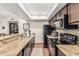 Modern kitchen design featuring granite counters, dark cabinets, and modern appliances at 7777 E Main St # 143, Scottsdale, AZ 85251