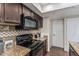 Modern kitchen features granite countertops and stainless steel microwave above electric range at 7777 E Main St # 143, Scottsdale, AZ 85251