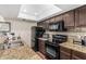 Updated kitchen features granite counters, stylish tile backsplash, and black appliances at 7777 E Main St # 143, Scottsdale, AZ 85251
