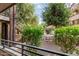 Relaxing condo patio view of meticulously landscaped grounds with mature trees and wrought iron staircase at 7777 E Main St # 143, Scottsdale, AZ 85251