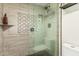 The stand up shower is features a glass wall, tile surround and modern fixtures at 7777 E Main St # 143, Scottsdale, AZ 85251