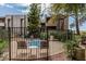 Outdoor community hot tub surrounded by wrought iron fencing and mature landscaping at 7777 E Main St # 143, Scottsdale, AZ 85251
