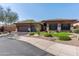Beautiful home with a three-car garage, desert landscaping with flowers and cacti, and a neatly manicured lawn at 7904 E Quill Ln, Scottsdale, AZ 85255