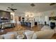 Open-concept living room flowing into a modern kitchen with a marble island, hardwood floors, and upscale decor at 7904 E Quill Ln, Scottsdale, AZ 85255