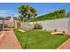 Spacious backyard featuring hammocks, corn hole, green turf, and mature landscaping at 8614 E Rose Ln, Scottsdale, AZ 85250