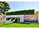 Lush backyard with a custom Scottsdale mural, hammocks, green turf, and mature landscaping at 8614 E Rose Ln, Scottsdale, AZ 85250