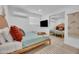 Bright bedroom with a minimalist design, featuring light wood floors and a mirrored closet at 8614 E Rose Ln, Scottsdale, AZ 85250