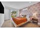Tranquil bedroom with a king bed, stylish wallpaper, and access to the outdoor space at 8614 E Rose Ln, Scottsdale, AZ 85250