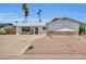 Charming single-story home with xeriscaping, desert landscaping, and a modern black front door at 8614 E Rose Ln, Scottsdale, AZ 85250
