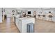 Open concept kitchen with large island, modern appliances and lots of seating, adjacent to the living room at 8614 E Rose Ln, Scottsdale, AZ 85250