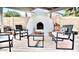 Relaxing outdoor patio area with a modern fireplace, comfortable seating and a cozy rug at 8614 E Rose Ln, Scottsdale, AZ 85250