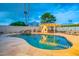 Backyard oasis featuring a large pool, waterfall, pizza oven, and string lights for evening enjoyment at 8614 E Rose Ln, Scottsdale, AZ 85250