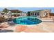 Backyard pool featuring an 8-foot deep end, rock waterfall, and spacious stone patio at 8614 E Rose Ln, Scottsdale, AZ 85250