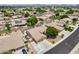 Wide aerial view showcasing a suburban home with a pool, landscaping, and neighborhood charm at 8738 W Runion Dr, Peoria, AZ 85382