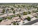 Expansive aerial view of a neighborhood featuring well-maintained homes, pools, and lush green spaces at 8738 W Runion Dr, Peoria, AZ 85382
