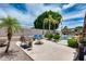 Resort-style backyard oasis features a pool, lush landscaping, and comfortable lounge chairs for relaxation at 8738 W Runion Dr, Peoria, AZ 85382