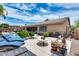 Backyard includes a pool, lounge chairs, lush greenery, and a serene outdoor living space perfect for relaxation at 8738 W Runion Dr, Peoria, AZ 85382