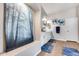 Bright bathroom featuring a large forest themed print and sleek white vanity at 8738 W Runion Dr, Peoria, AZ 85382