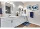 Well-lit bathroom featuring double mirrors, white vanities, and clean finishes at 8738 W Runion Dr, Peoria, AZ 85382