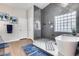 Modern bathroom with large shower, soaking tub, and light-filled window at 8738 W Runion Dr, Peoria, AZ 85382