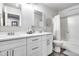 Bathroom featuring a double sink vanity, modern fixtures and a shower-tub combination with a stylish shower curtain at 8738 W Runion Dr, Peoria, AZ 85382