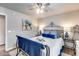 Comfortable bedroom featuring a wrought iron bed, plush bedding, and a ceiling fan at 8738 W Runion Dr, Peoria, AZ 85382