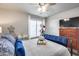 Comfortable bedroom featuring a wrought iron bed, plush bedding, and a ceiling fan at 8738 W Runion Dr, Peoria, AZ 85382