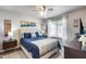 Comfortable bedroom with a ceiling fan, plush bedding, and stylish decor, creating a relaxing retreat at 8738 W Runion Dr, Peoria, AZ 85382