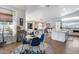 Bright dining area with hardwood floors, modern decor, and a stylish round table with blue chairs at 8738 W Runion Dr, Peoria, AZ 85382