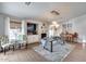 Modern dining room featuring stylish decor, light fixture, fireplace, and hardwood flooring at 8738 W Runion Dr, Peoria, AZ 85382
