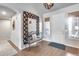 Inviting entryway with decorative mirror, bench, and stylish rug, offering a welcoming space at 8738 W Runion Dr, Peoria, AZ 85382