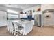 Stylish kitchen features a large island with seating, stainless appliances, and ample counter space at 8738 W Runion Dr, Peoria, AZ 85382