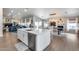 Open concept living space with modern kitchen, seamless access to living room and dining areas at 8738 W Runion Dr, Peoria, AZ 85382