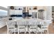 Modern kitchen with stainless steel appliances, white cabinets, large island and stylish blue backsplash at 8738 W Runion Dr, Peoria, AZ 85382