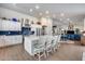 Expansive kitchen with a central island, stainless appliances, and seamless flow to the living spaces at 8738 W Runion Dr, Peoria, AZ 85382