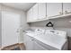 Bright laundry room with ample cabinet space and modern, high efficiency, LG washer and dryer at 8738 W Runion Dr, Peoria, AZ 85382