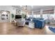 Open living room with hardwood floors, large windows, and vaulted ceiling at 8738 W Runion Dr, Peoria, AZ 85382